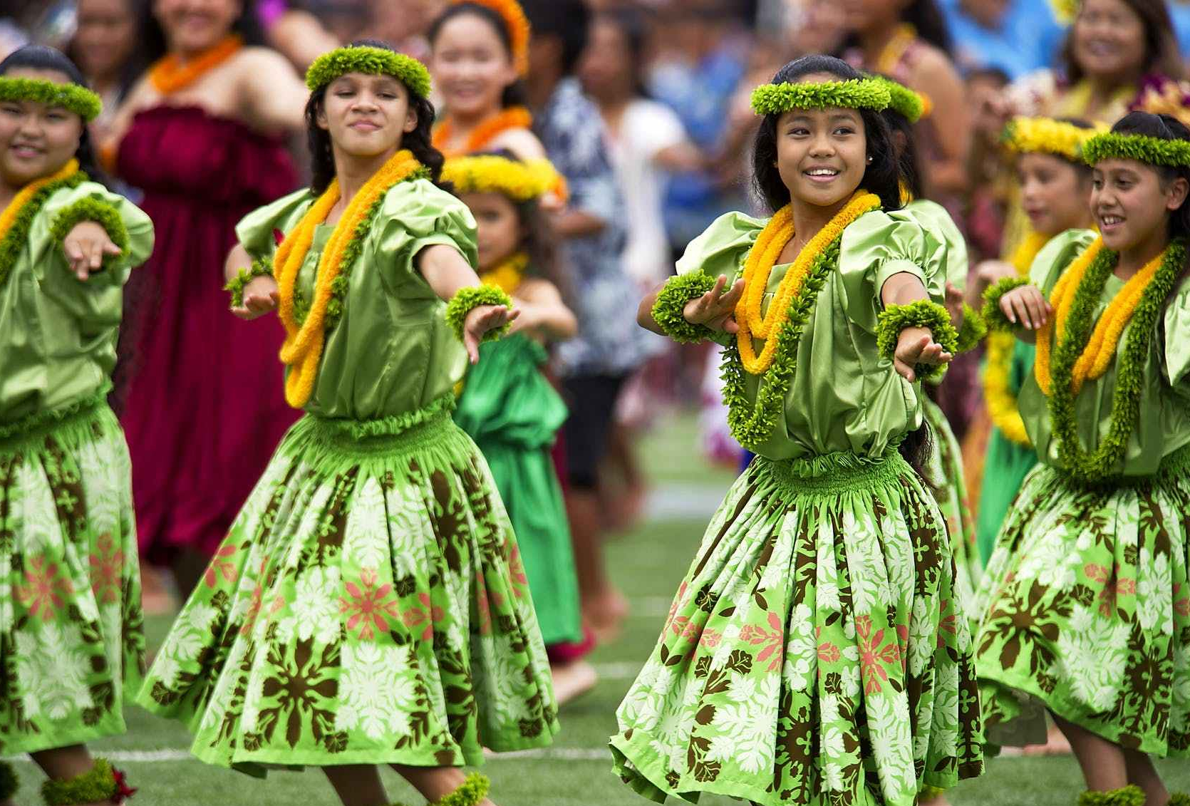 girls dancing in traditional polynesian dresses