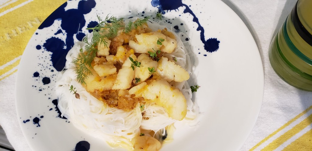 finished coconut, lemon and ginger scallops on rice noodles