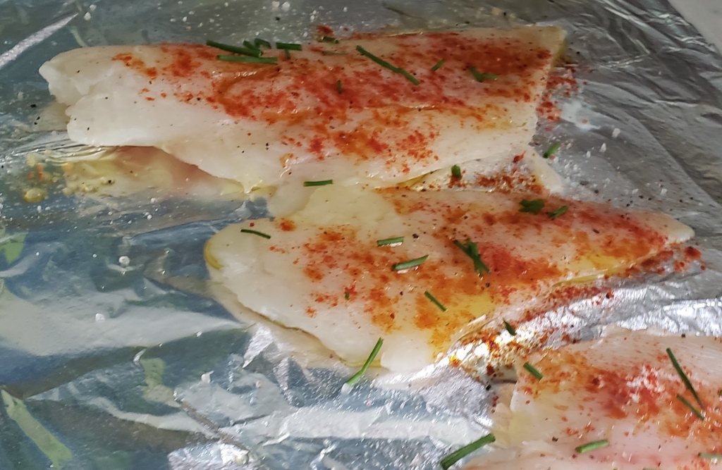 fish filets drizzled with olive oil, and sprinkled with herbs and spices