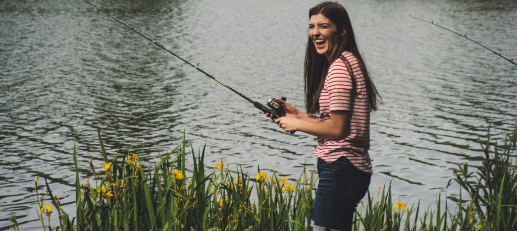 Smiling girl fishing