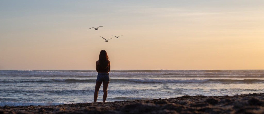 young girl watching the ocean