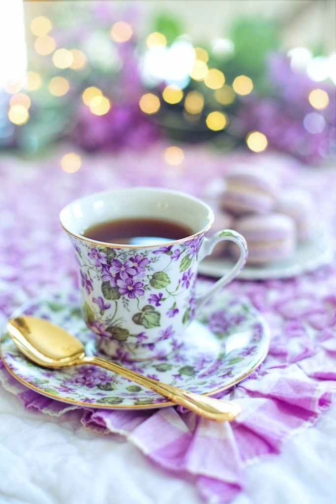 violet covered tea cup with gold spoon