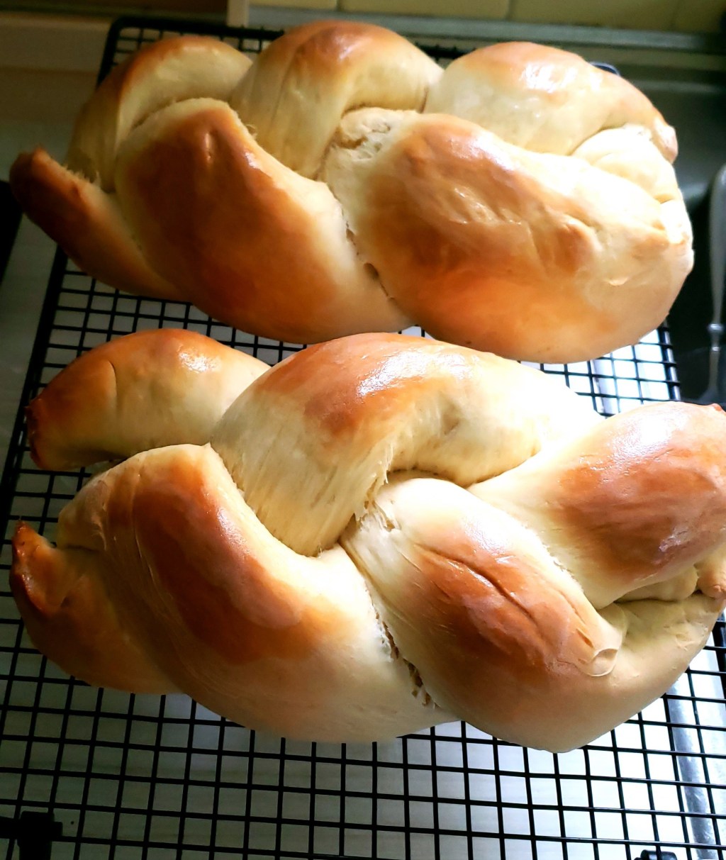 two loaves cooling on a rack.