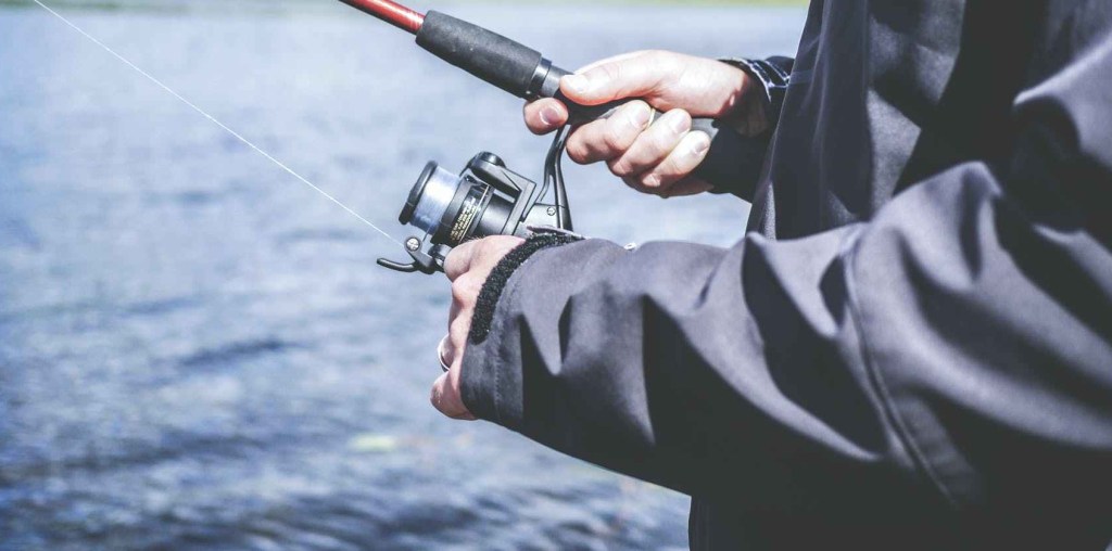 Man reeling in a fishing rod