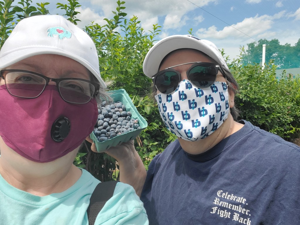Beth and I in masks, out in the blueberry fields