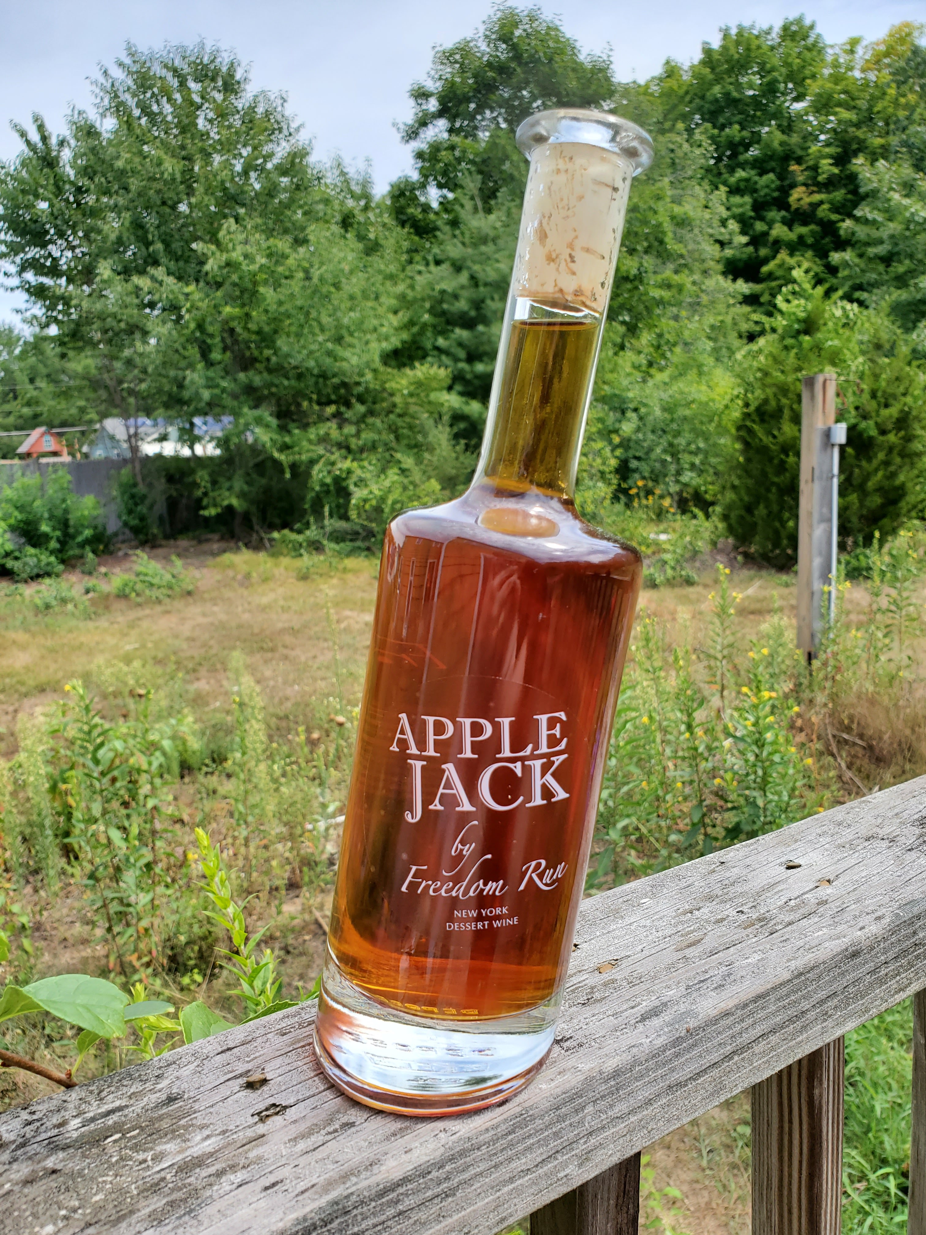 slanted bottle of apple wine