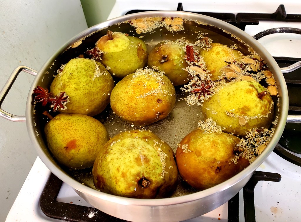 pears simmering in their spicy bath
