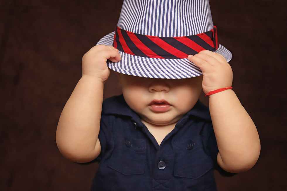 little boy in striped fedora