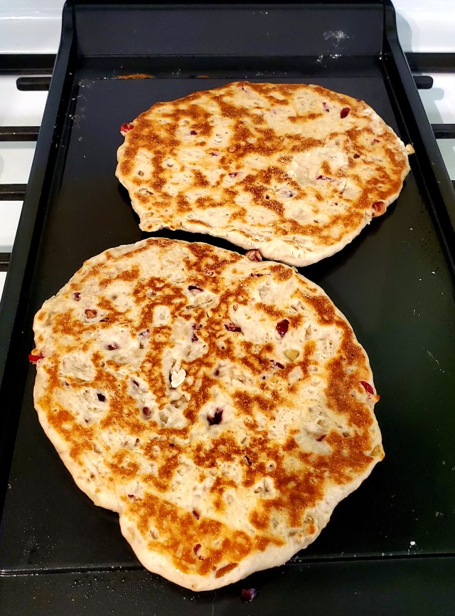 Two naans browned on top