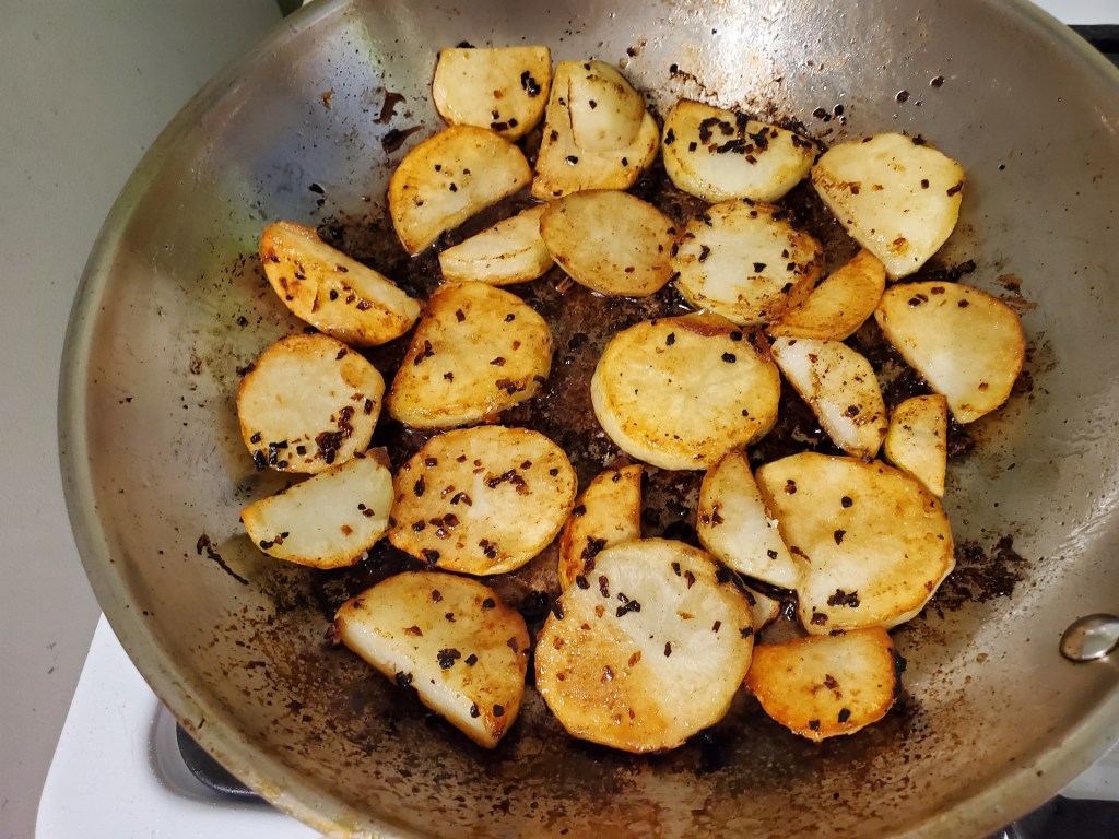 Potatoes and onions browned in the pan