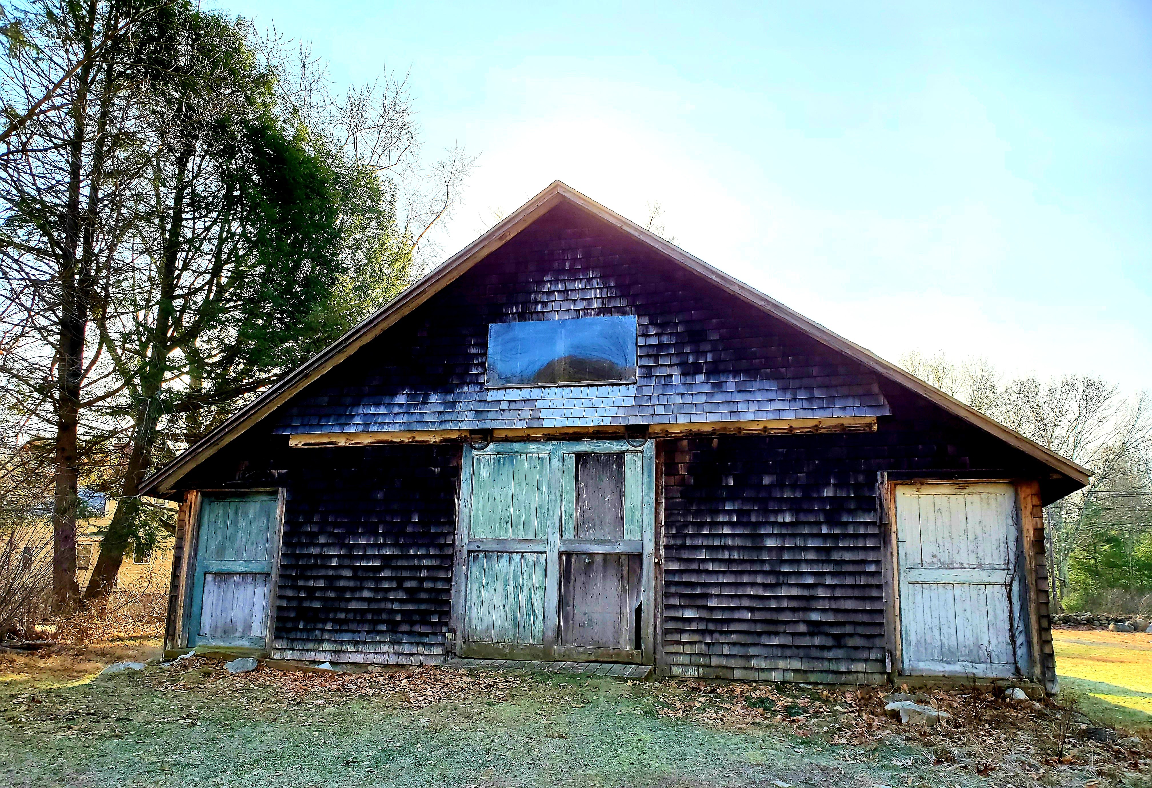 Old barn with worn doors and shingles