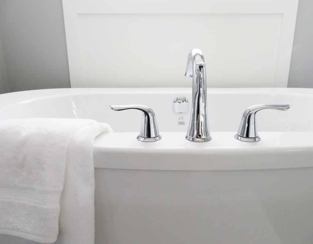 White tub with chrome faucet and white towel